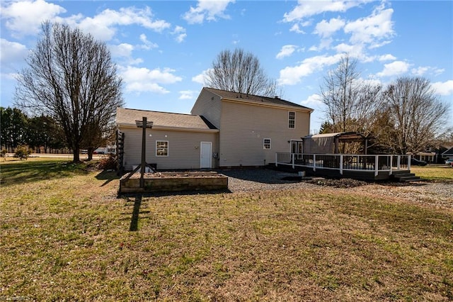 rear view of property with a lawn and a deck