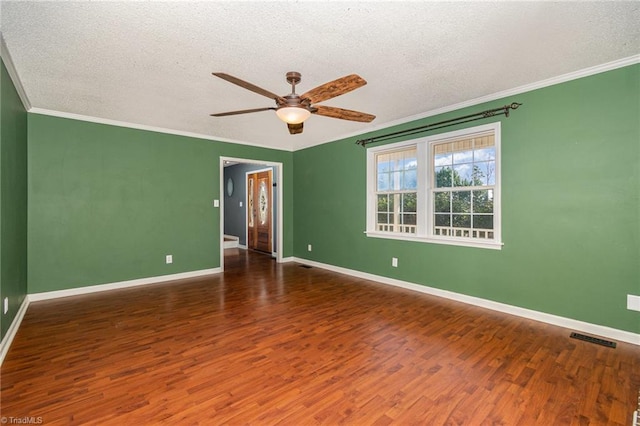 empty room with dark hardwood / wood-style flooring, ceiling fan, crown molding, and a textured ceiling