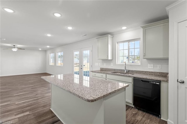 kitchen featuring dishwasher, dark wood-type flooring, a sink, and a center island