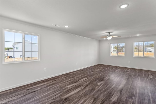 spare room with baseboards, ornamental molding, dark wood finished floors, and recessed lighting