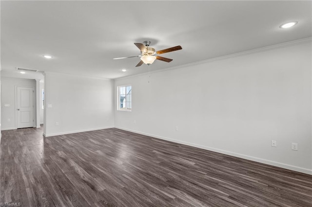 empty room with baseboards, visible vents, ceiling fan, ornamental molding, and dark wood-type flooring