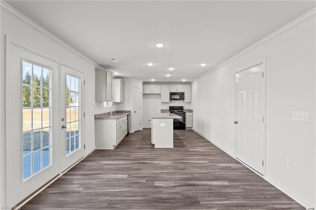 kitchen featuring recessed lighting, dark wood-type flooring, ornamental molding, french doors, and black appliances