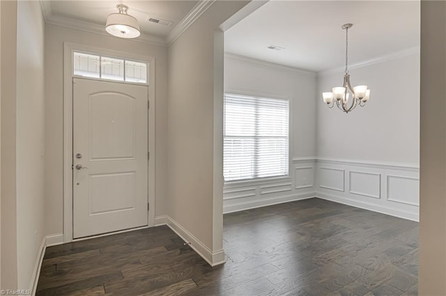 entrance foyer featuring crown molding, dark hardwood / wood-style floors, and a chandelier