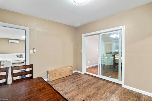 516 John St, Eden, NC 27288 - interior space featuring a wall mounted air conditioner, wood finished floors, and baseboards