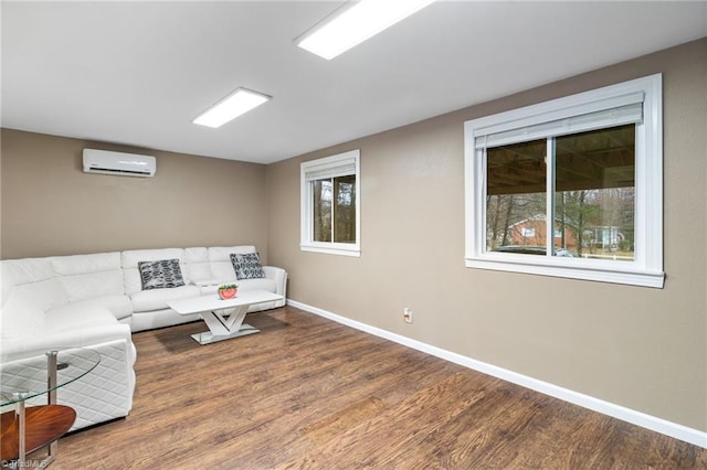 516 John St, Eden, NC 27288 - living area featuring a wall mounted AC, wood finished floors, and baseboards