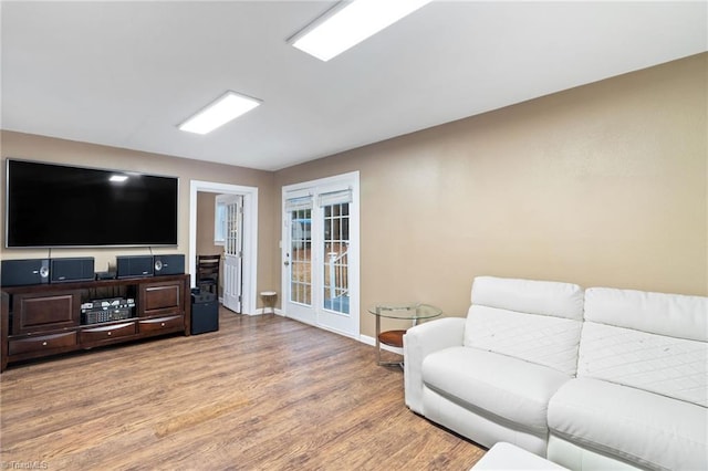 516 John St, Eden, NC 27288 - living room featuring light wood-style flooring, baseboards, and french doors