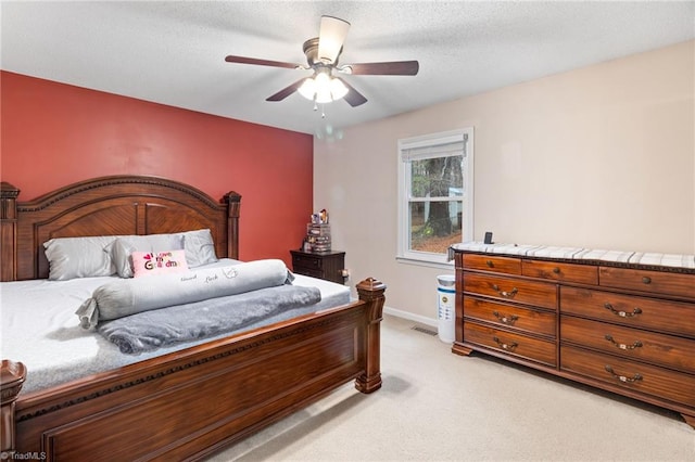 516 John St, Eden, NC 27288 - bedroom with light carpet, ceiling fan, baseboards, and a textured ceiling