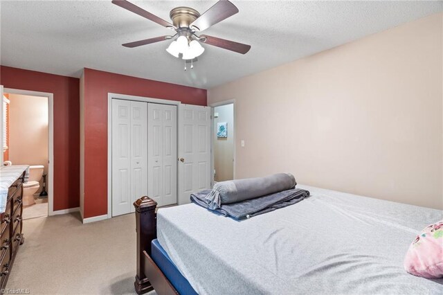 516 John St, Eden, NC 27288 - bedroom with a closet, light colored carpet, a textured ceiling, and ensuite bathroom