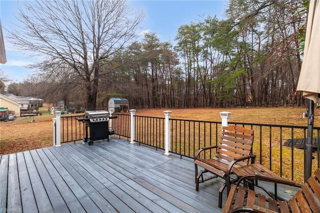 516 John St, Eden, NC 27288 - wooden deck with an outdoor structure, grilling area, and a yard