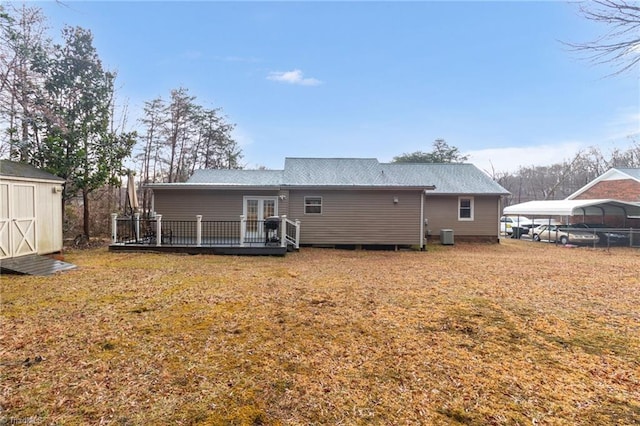516 John St, Eden, NC 27288 - back of property featuring a storage shed, a deck, a lawn, and an outdoor structure