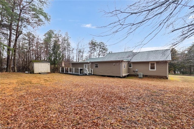 516 John St, Eden, NC 27288 - back of property featuring a shingled roof, an outbuilding, a wooden deck, and a storage unit