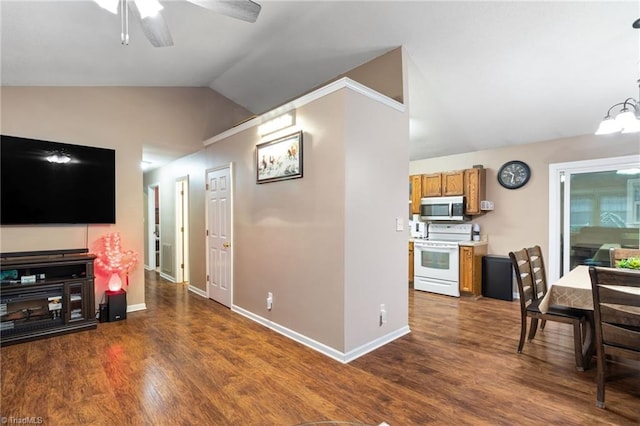 516 John St, Eden, NC 27288 - kitchen with white range with electric stovetop, stainless steel microwave, brown cabinets, dark wood-style flooring, and vaulted ceiling