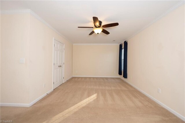 unfurnished room featuring light colored carpet, ceiling fan, and ornamental molding