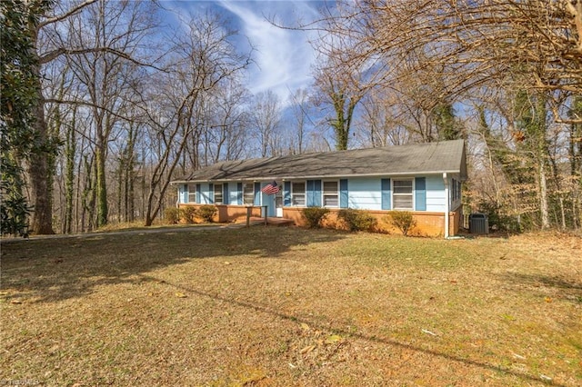 ranch-style house featuring a front yard, cooling unit, and brick siding