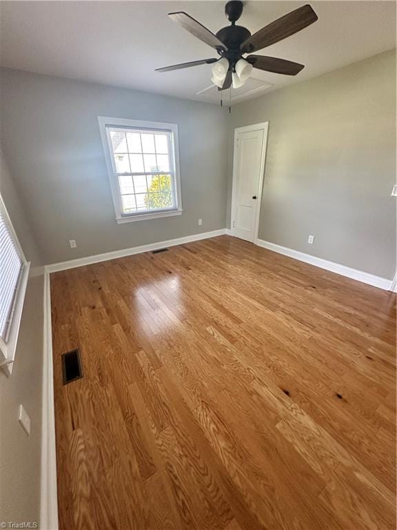 unfurnished room featuring ceiling fan and hardwood / wood-style flooring