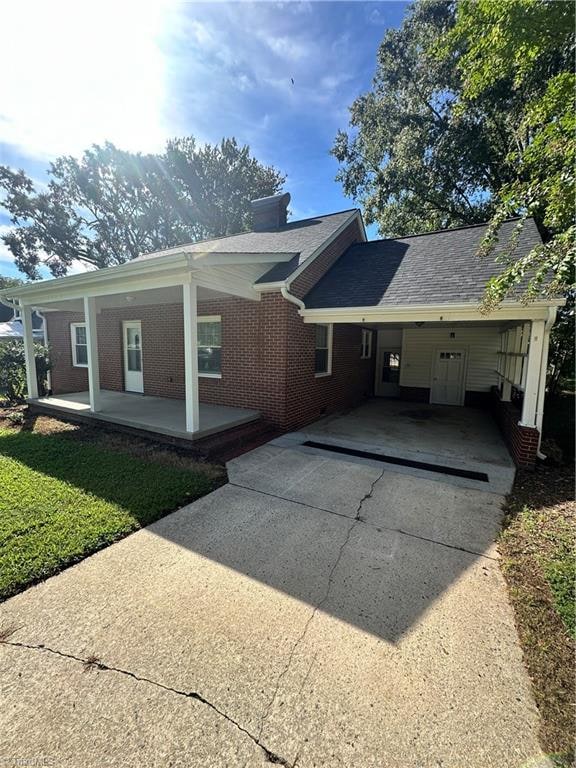 back of property with a carport