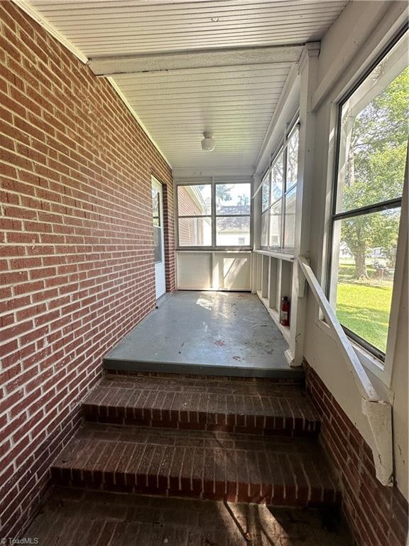 unfurnished sunroom featuring plenty of natural light