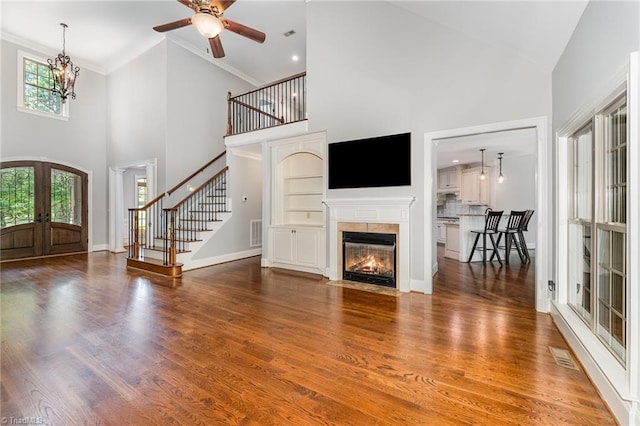 5216 Harley Stafford Dr, Oak Ridge, NC 27310 - unfurnished living room featuring french doors, high vaulted ceiling, stairway, crown molding, and ceiling fan