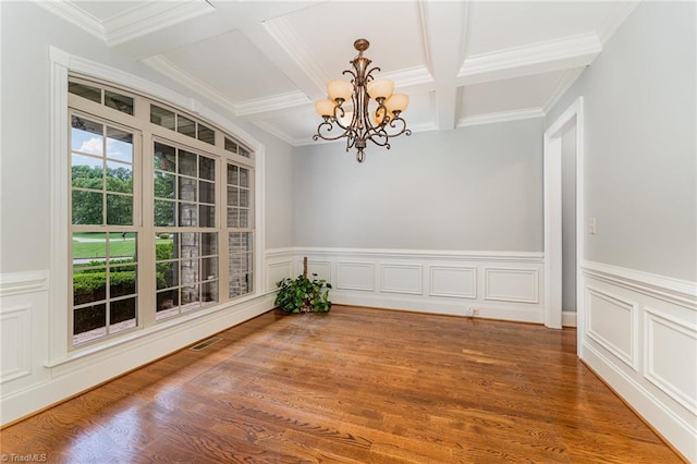 5216 Harley Stafford Dr, Oak Ridge, NC 27310 - unfurnished room with a chandelier, coffered ceiling, beam ceiling, crown molding, and wood finished floors