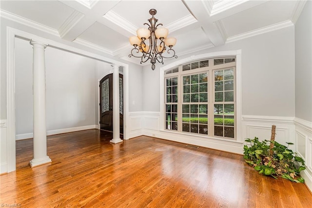 5216 Harley Stafford Dr, Oak Ridge, NC 27310 - unfurnished dining area with ornate columns, a chandelier, coffered ceiling, wood finished floors, and beam ceiling