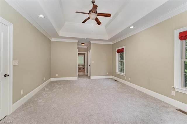 5216 Harley Stafford Dr, Oak Ridge, NC 27310 - empty room featuring a raised ceiling, a ceiling fan, light colored carpet, crown molding, and recessed lighting