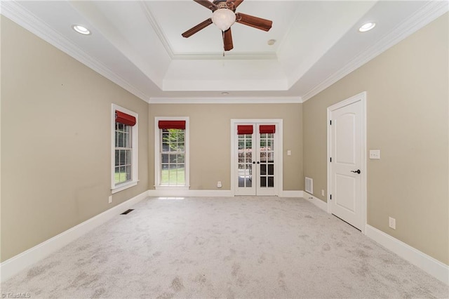 5216 Harley Stafford Dr, Oak Ridge, NC 27310 - empty room featuring french doors, a tray ceiling, crown molding, a ceiling fan, and carpet flooring