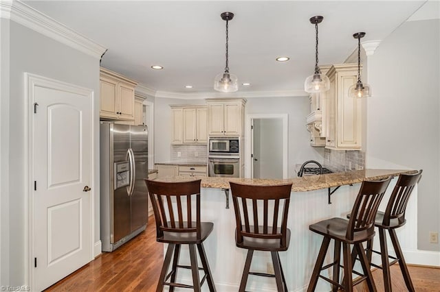 5216 Harley Stafford Dr, Oak Ridge, NC 27310 - kitchen with stainless steel appliances, cream cabinetry, a peninsula, decorative backsplash, and crown molding