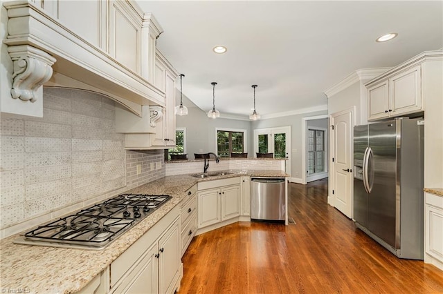 5216 Harley Stafford Dr, Oak Ridge, NC 27310 - kitchen featuring appliances with stainless steel finishes, a peninsula, tasteful backsplash, custom range hood, and decorative light fixtures