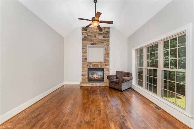5216 Harley Stafford Dr, Oak Ridge, NC 27310 - unfurnished living room featuring ceiling fan, plenty of natural light, a fireplace, wood finished floors, and lofted ceiling