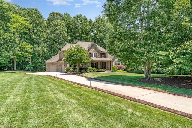 5216 Harley Stafford Dr, Oak Ridge, NC 27310 - view of front facade featuring concrete driveway, a front lawn, and an attached garage