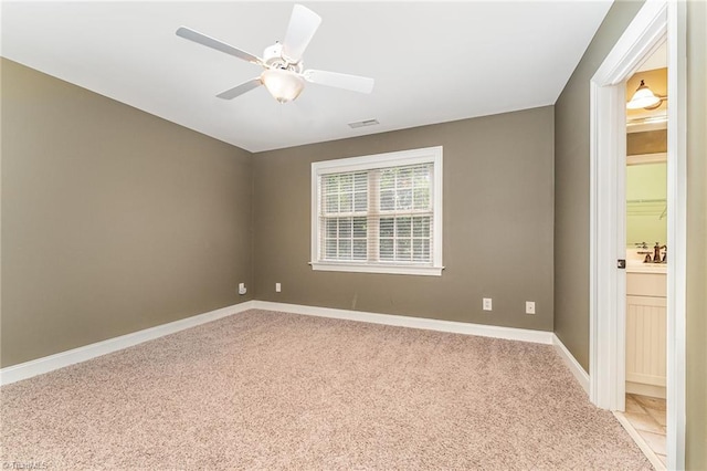 5216 Harley Stafford Dr, Oak Ridge, NC 27310 - empty room featuring light colored carpet and a ceiling fan