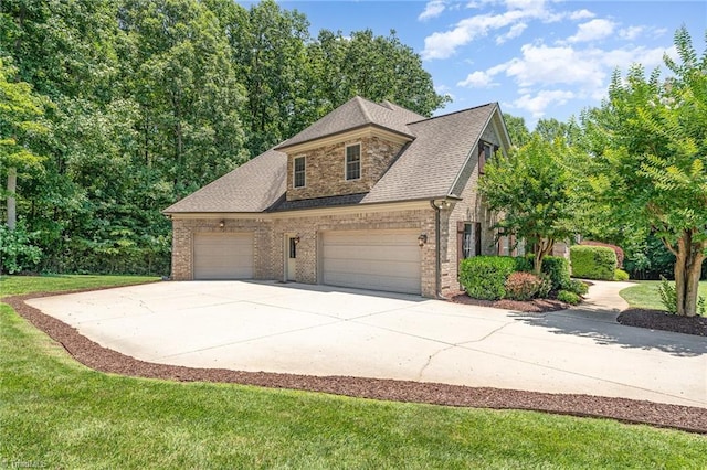 5216 Harley Stafford Dr, Oak Ridge, NC 27310 - view of property exterior featuring brick siding, an attached garage, concrete driveway, a lawn, and a shingled roof