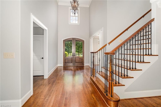 5216 Harley Stafford Dr, Oak Ridge, NC 27310 - entrance foyer with french doors, wood finished floors, stairs, crown molding, and a high ceiling