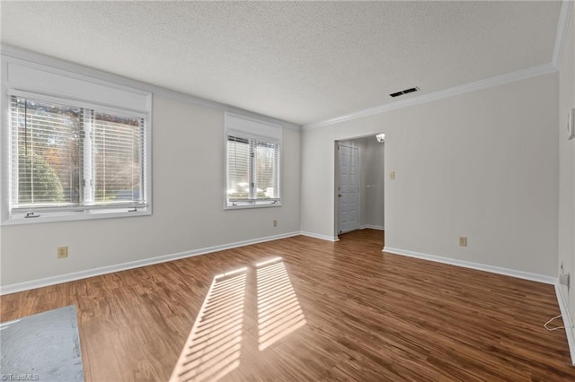 empty room featuring a wealth of natural light and dark hardwood / wood-style flooring