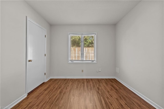 spare room featuring wood-type flooring