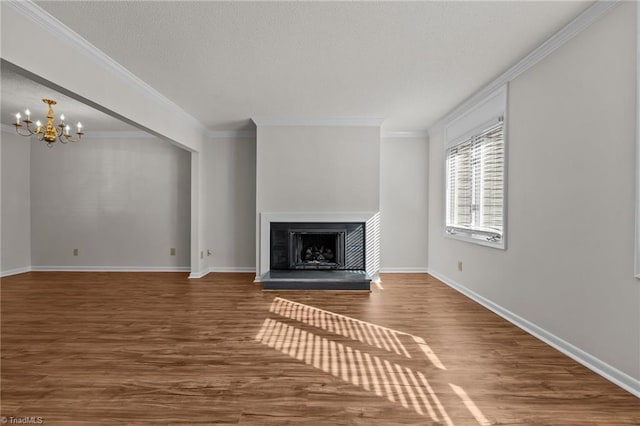 unfurnished living room featuring dark hardwood / wood-style flooring, crown molding, and a chandelier