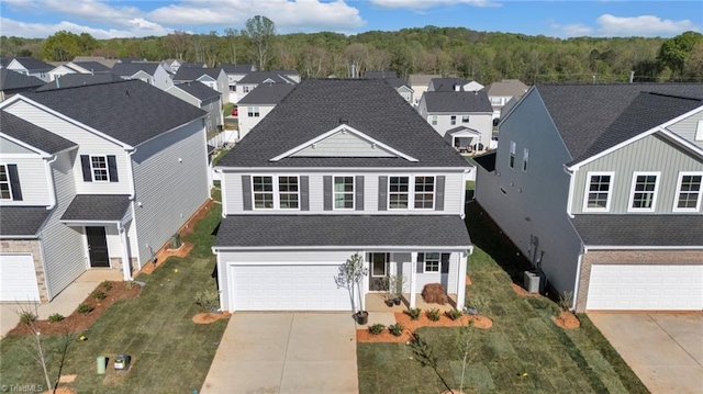 2533 Raspberry Hill Dr, Winston-Salem, NC 27106 - traditional-style home featuring driveway, an attached garage, roof with shingles, and a residential view