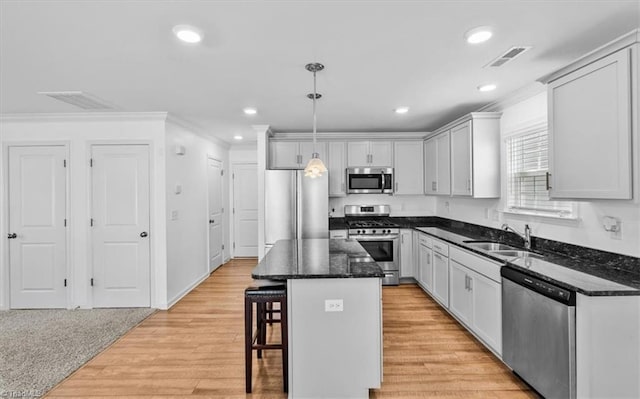824 Sage Hill Dr, Jamestown, NC 27282 - kitchen featuring appliances with stainless steel finishes, a kitchen breakfast bar, crown molding, a kitchen island, and pendant lighting
