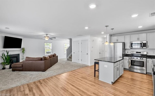 824 Sage Hill Dr, Jamestown, NC 27282 - kitchen featuring stainless steel appliances, a kitchen bar, dark countertops, open floor plan, and recessed lighting