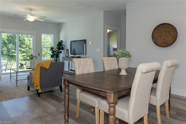 dining space with wood finished floors and a ceiling fan