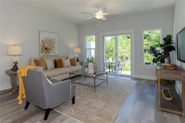 living area with wood finished floors, ceiling fan, and baseboards
