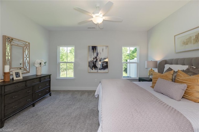 bedroom featuring baseboards, carpet flooring, and a ceiling fan
