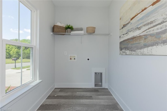 clothes washing area with electric dryer hookup, wood finished floors, hookup for a washing machine, and baseboards