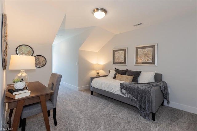 carpeted bedroom with baseboards and vaulted ceiling
