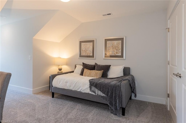 carpeted bedroom with baseboards and vaulted ceiling
