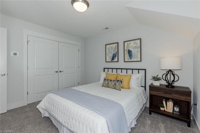bedroom featuring carpet floors, a closet, lofted ceiling, and baseboards