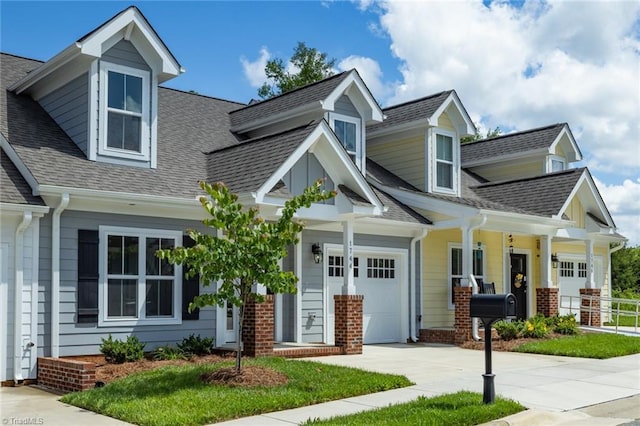 view of front of property with driveway, covered porch, a garage, a shingled roof, and brick siding