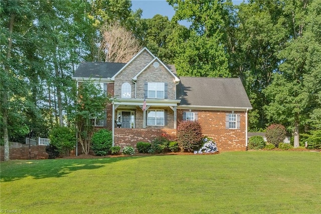 view of front of house with stone siding, a front lawn, and brick siding