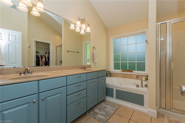 full bathroom with tile patterned floors, a stall shower, a sink, and an inviting chandelier