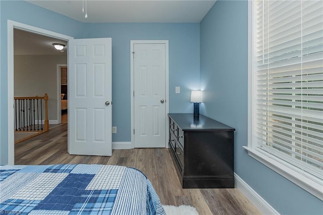 bedroom featuring baseboards and wood finished floors